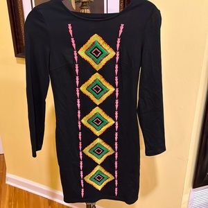 Date night mini black dress with front embroidery. Long sleeves. Fits a size 4